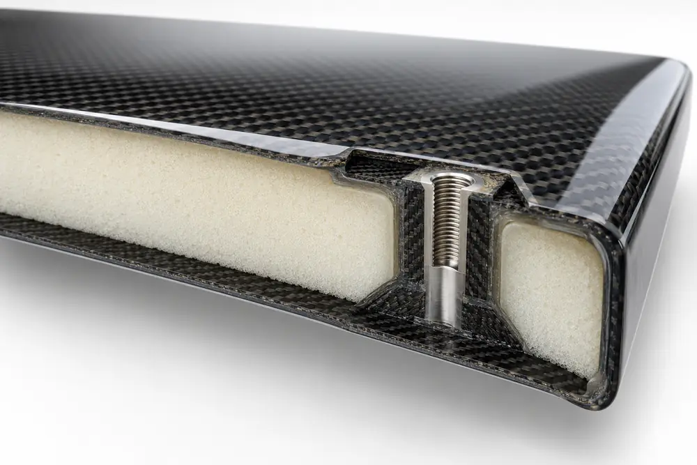 Carbon fiber sandwich panel with foam core and reinforced hardpoint